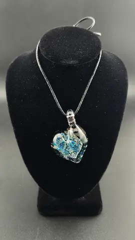 Blue Ember, a hand-blown glass heart pendant by Jared Omas in crushed opal and dichroic glass with flashes of blue and silver
