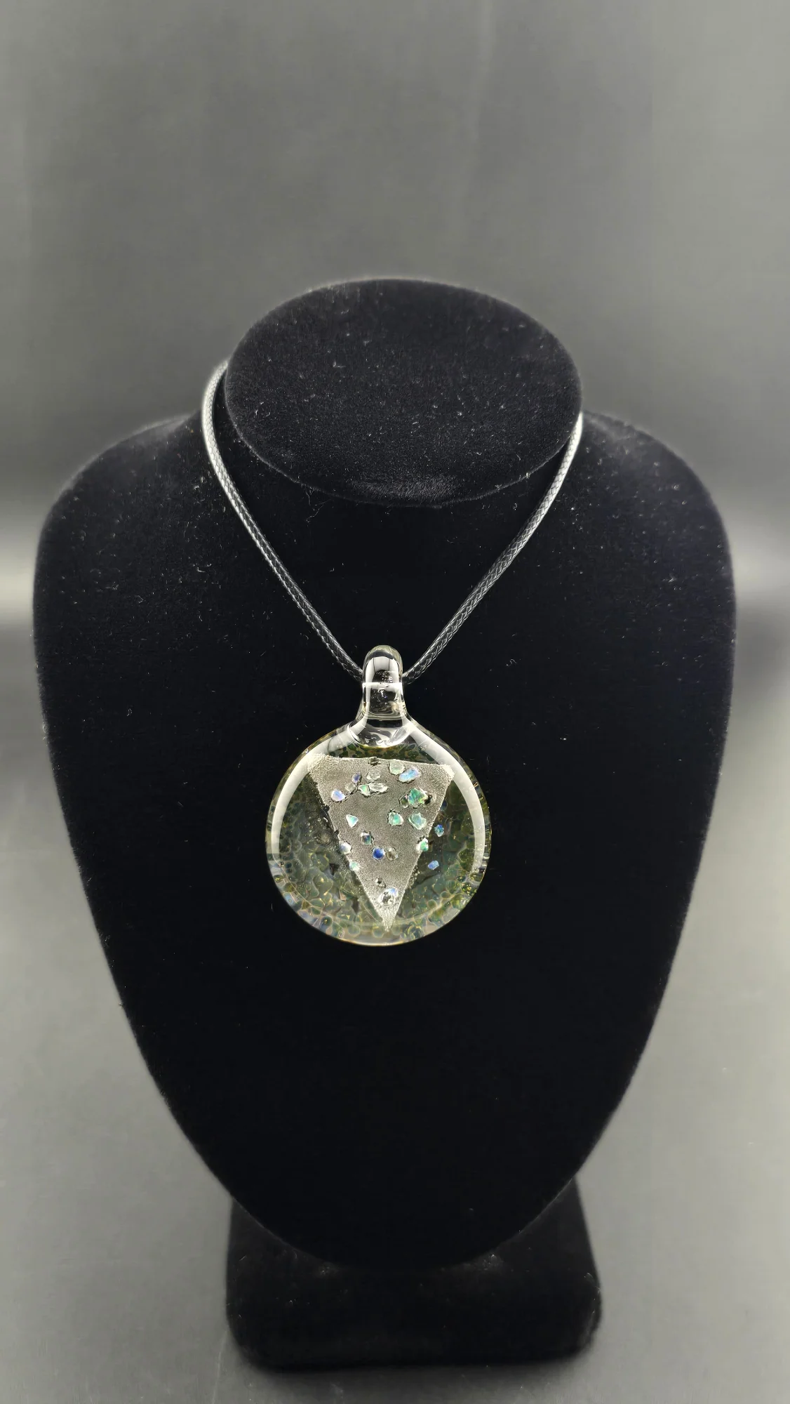 Opal Shield, a hand-blown glass pendant by Jared Omas with a triangular dichroic and crushed opal design over colourful frit