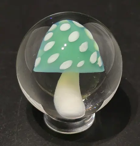 Enchanted Mushroom, a hand-blown glass marble by Jared Omas with a mint green cap and creamy white spots